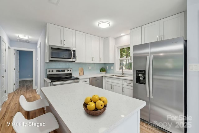 5414 Leaford Ct, Charlotte, NC 28227 - kitchen featuring stainless steel appliances, a sink, light wood-type flooring, and light countertops