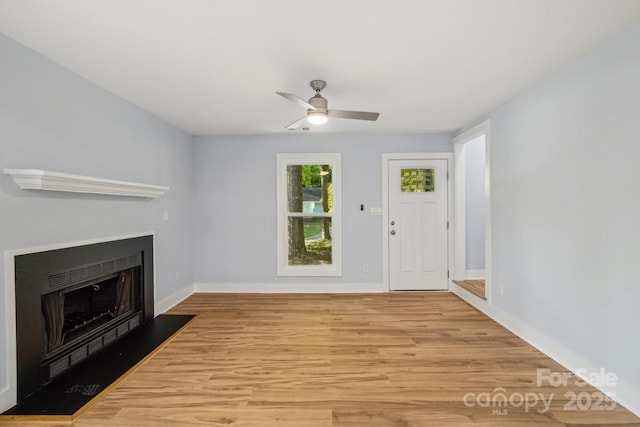 5414 Leaford Ct, Charlotte, NC 28227 - unfurnished living room featuring a fireplace with flush hearth, light wood-style flooring, baseboards, and ceiling fan