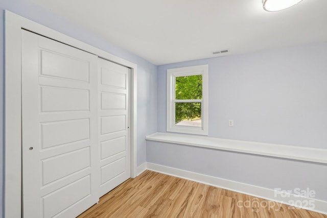 5414 Leaford Ct, Charlotte, NC 28227 - unfurnished bedroom with baseboards, light wood-style flooring, and a closet