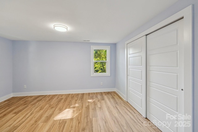 5414 Leaford Ct, Charlotte, NC 28227 - unfurnished bedroom featuring light wood-style flooring, baseboards, and a closet