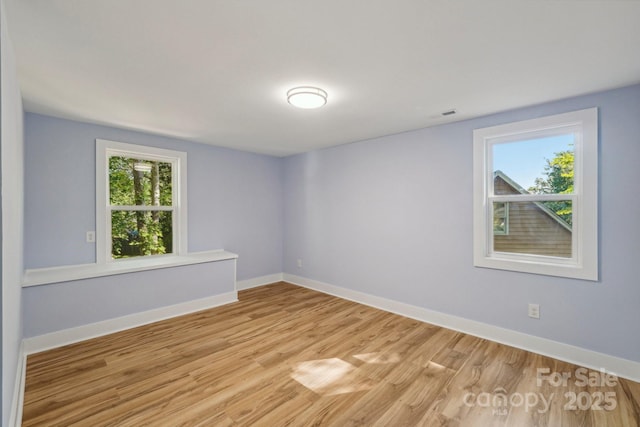 5414 Leaford Ct, Charlotte, NC 28227 - empty room featuring plenty of natural light, light wood-style floors, and baseboards
