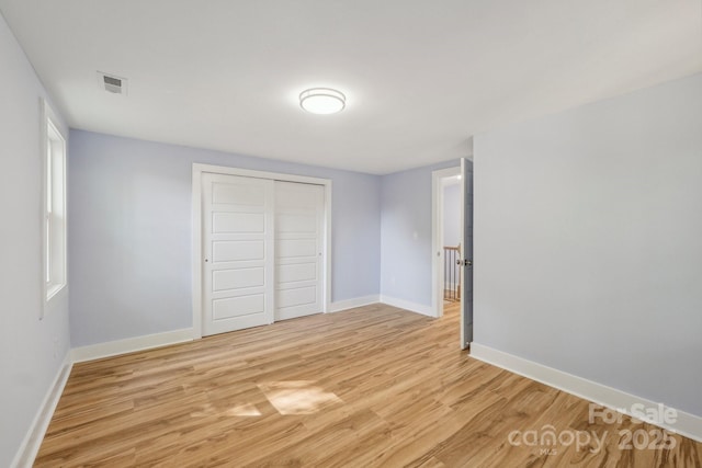 5414 Leaford Ct, Charlotte, NC 28227 - unfurnished bedroom with light wood-style flooring, a closet, and baseboards