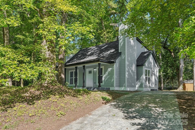 5414 Leaford Ct, Charlotte, NC 28227 - view of front of property featuring a porch, driveway, a chimney, and a shingled roof