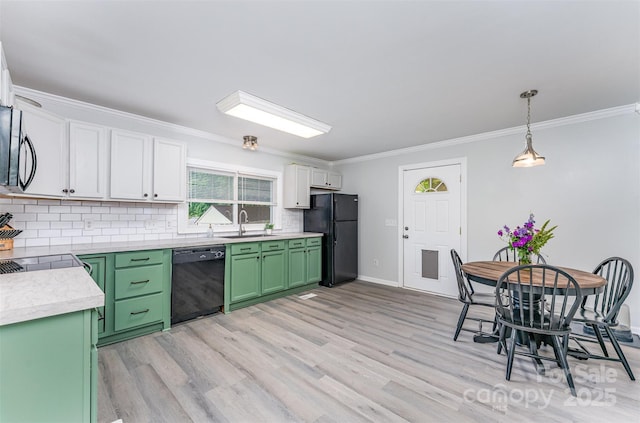 910 W A St, Kannapolis, NC 28081 - kitchen featuring black appliances, green cabinets, a sink, crown molding, and backsplash