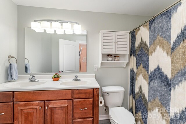910 W A St, Kannapolis, NC 28081 - bathroom featuring double vanity, toilet, and a shower with curtain