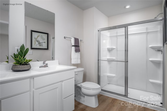 206 Rose Ln Unit 1499, Pageland, SC 29728 - bathroom featuring double vanity, wood finished floors, a shower stall, toilet, and recessed lighting