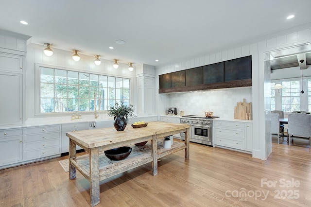 2270 New Gray Rock Rd, Fort Mill, SC 29708 - kitchen with double oven range, light countertops, light wood-type flooring, backsplash, and recessed lighting