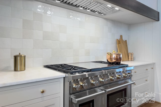 2270 New Gray Rock Rd, Fort Mill, SC 29708 - kitchen featuring range with two ovens, decorative backsplash, light countertops, and wall chimney exhaust hood