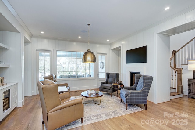 2270 New Gray Rock Rd, Fort Mill, SC 29708 - living room featuring ornamental molding, stairway, light wood finished floors, and a fireplace