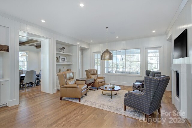 2270 New Gray Rock Rd, Fort Mill, SC 29708 - living room with light wood-style floors, built in shelves, ornamental molding, a fireplace, and recessed lighting