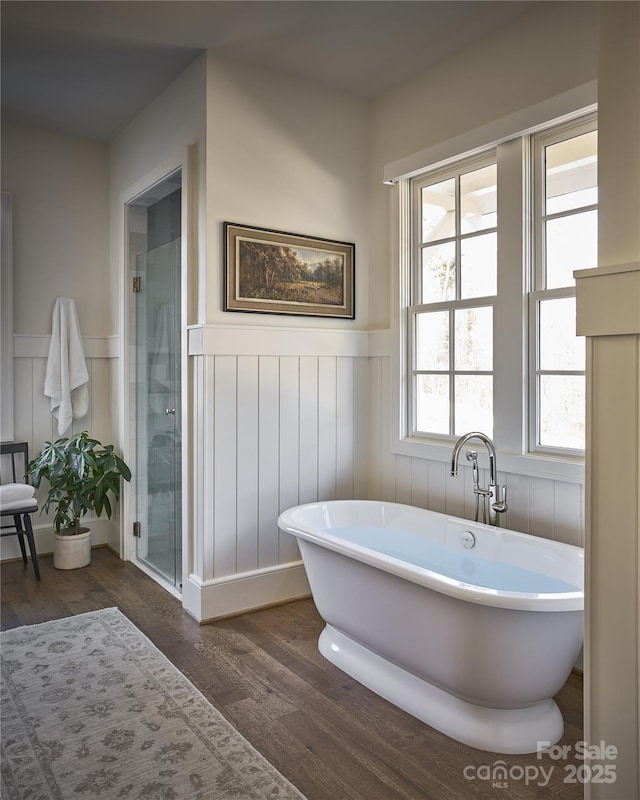 2270 New Gray Rock Rd, Fort Mill, SC 29708 - full bathroom featuring wainscoting, wood finished floors, a freestanding bath, and a shower stall