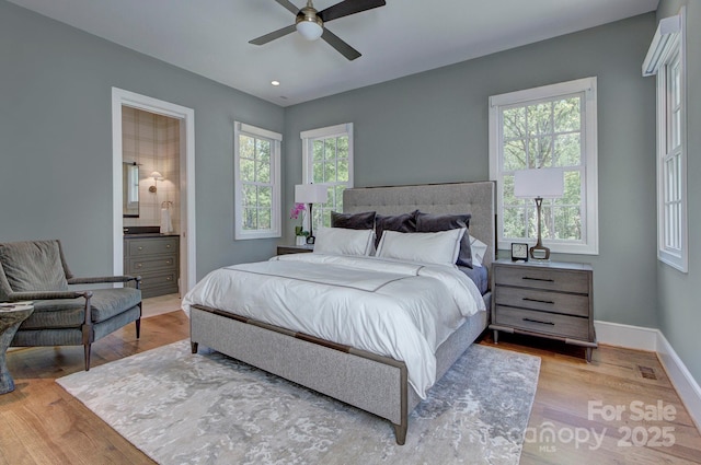 2270 New Gray Rock Rd, Fort Mill, SC 29708 - bedroom featuring wood finished floors, multiple windows, baseboards, connected bathroom, and recessed lighting