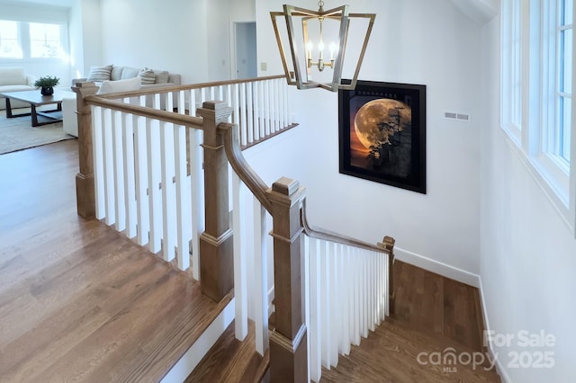 2270 New Gray Rock Rd, Fort Mill, SC 29708 - staircase featuring a chandelier, wood finished floors, and baseboards