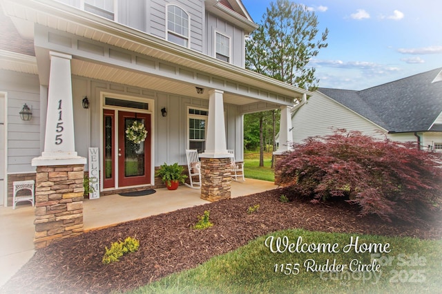 1155 Rudder Cir, Salisbury, NC 28146 - doorway to property featuring covered porch, board and batten siding, and stone siding