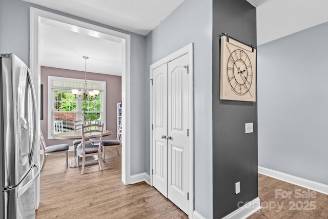 1155 Rudder Cir, Salisbury, NC 28146 - entrance foyer with a chandelier, light wood-type flooring, and baseboards