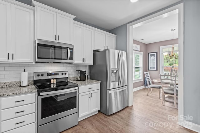 1155 Rudder Cir, Salisbury, NC 28146 - kitchen with appliances with stainless steel finishes, baseboards, light wood finished floors, backsplash, and white cabinets
