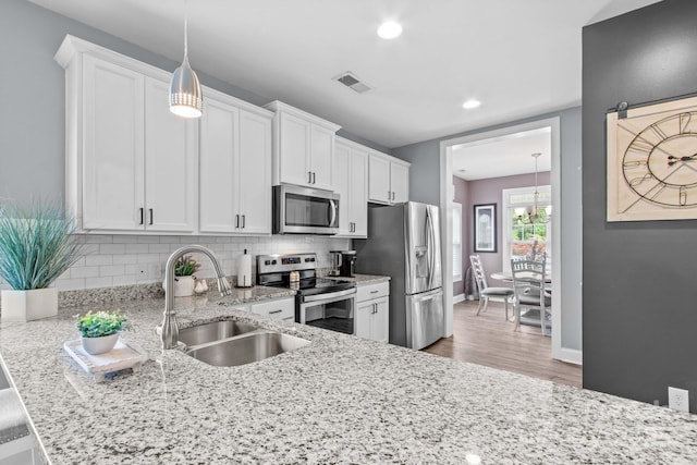 1155 Rudder Cir, Salisbury, NC 28146 - kitchen featuring stainless steel appliances, a sink, decorative backsplash, white cabinetry, and recessed lighting