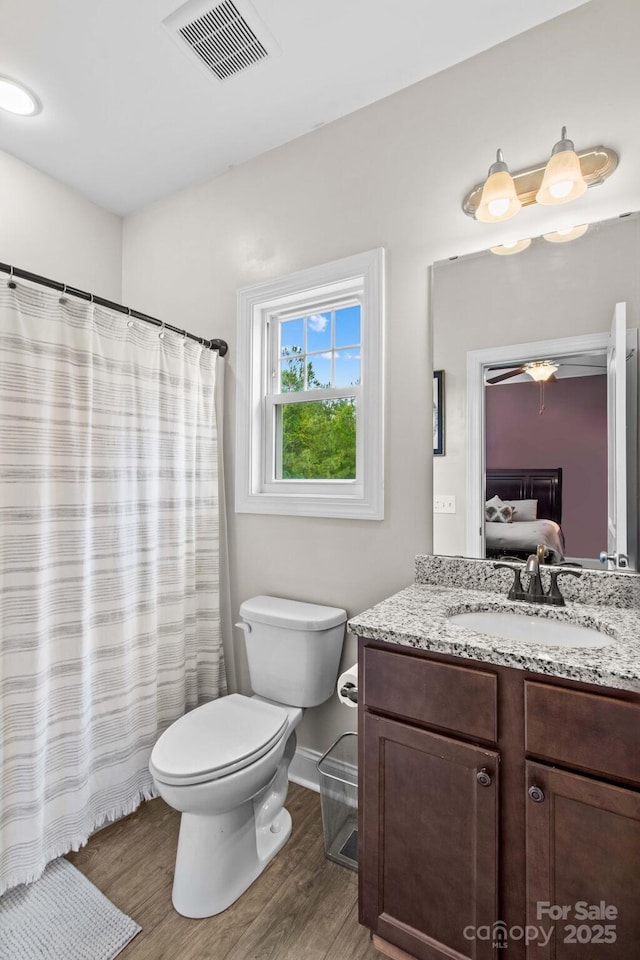 1155 Rudder Cir, Salisbury, NC 28146 - full bath with vanity, toilet, wood finished floors, and baseboards