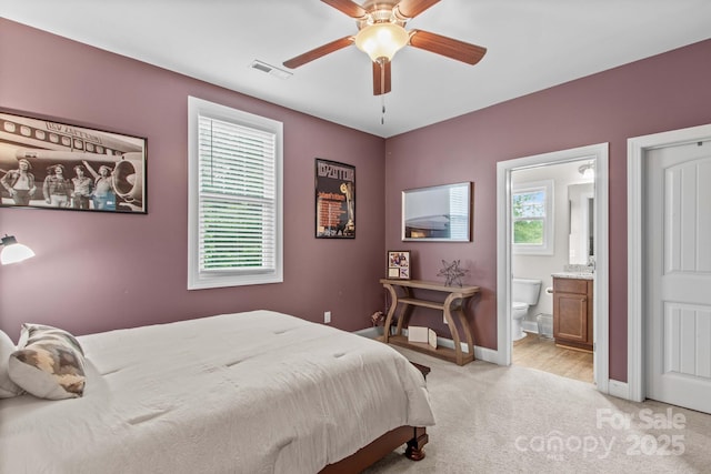 1155 Rudder Cir, Salisbury, NC 28146 - bedroom with light carpet, baseboards, ensuite bath, and a ceiling fan