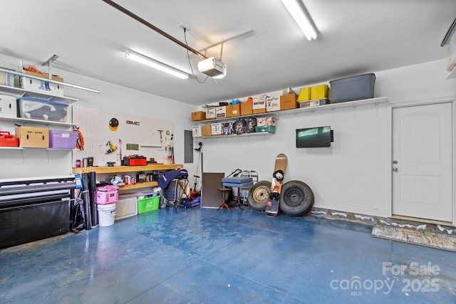 1155 Rudder Cir, Salisbury, NC 28146 - garage featuring a garage door opener, electric panel, and a workshop area