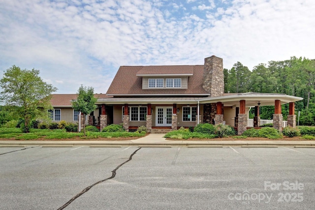 1155 Rudder Cir, Salisbury, NC 28146 - view of front of property featuring french doors, a chimney, covered porch, and stone siding