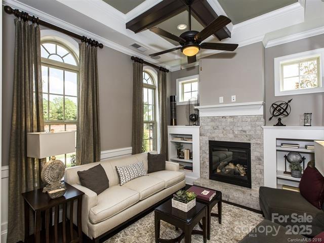6510 Honeymeade Cir, Charlotte, NC 28277 - living area with coffered ceiling, a ceiling fan, a fireplace, ornamental molding, and beam ceiling