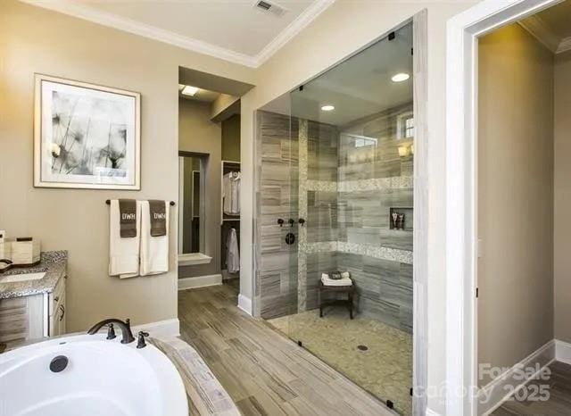 6510 Honeymeade Cir, Charlotte, NC 28277 - bathroom with ornamental molding, a shower stall, vanity, wood finished floors, and a bath