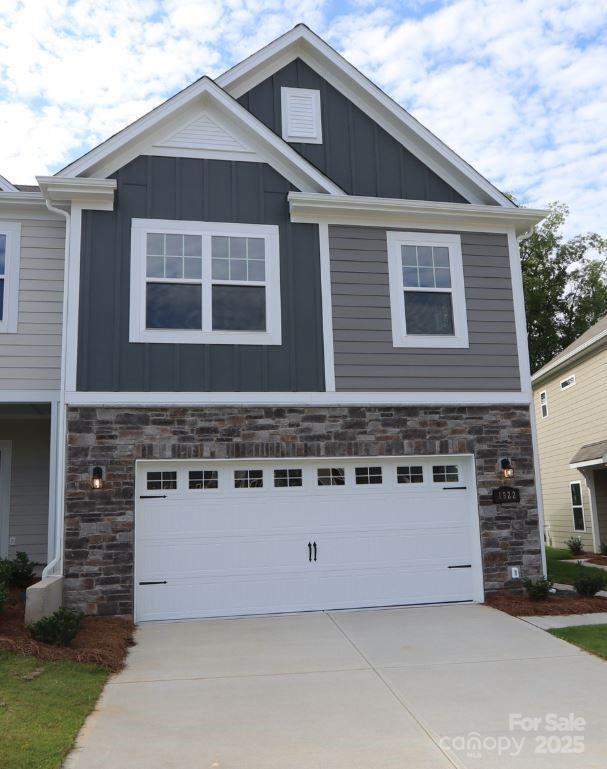 1922 Highland Park Dr, Charlotte, NC 28269 - craftsman inspired home with board and batten siding, stone siding, and an attached garage