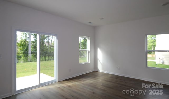 1922 Highland Park Dr, Charlotte, NC 28269 - empty room featuring plenty of natural light, wood finished floors, and baseboards