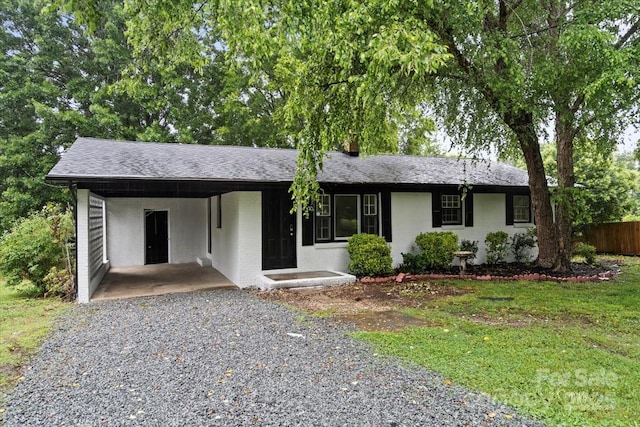 818 Stowe Ln, Gastonia, NC 28056 - ranch-style house featuring driveway, a carport, and a shingled roof
