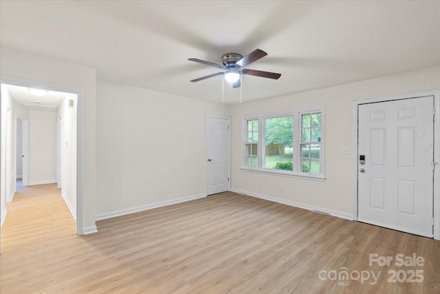 818 Stowe Ln, Gastonia, NC 28056 - foyer entrance featuring light wood-type flooring, ceiling fan, and baseboards