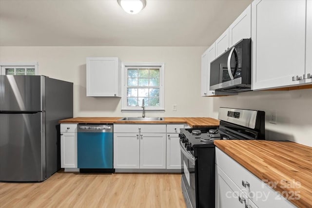 818 Stowe Ln, Gastonia, NC 28056 - kitchen with wooden counters, appliances with stainless steel finishes, a sink, and light wood-style floors