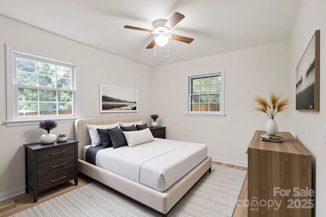 818 Stowe Ln, Gastonia, NC 28056 - bedroom with baseboards, light wood-type flooring, and a ceiling fan