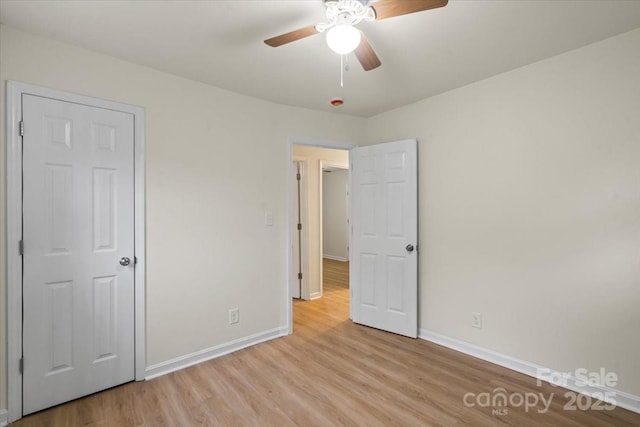818 Stowe Ln, Gastonia, NC 28056 - unfurnished bedroom with light wood-style flooring, baseboards, and a ceiling fan