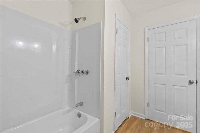 818 Stowe Ln, Gastonia, NC 28056 - bathroom featuring shower / bathtub combination and wood finished floors