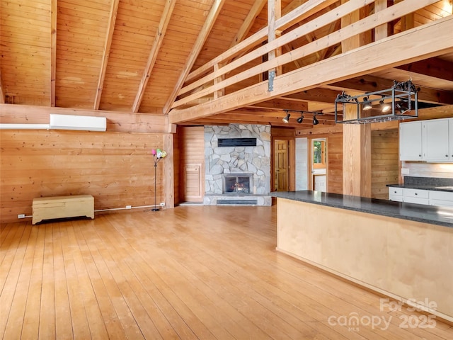 429 Biodome Dr, Waynesville, NC 28785 - kitchen with open floor plan, wood ceiling, hardwood / wood-style floors, dark countertops, and a fireplace