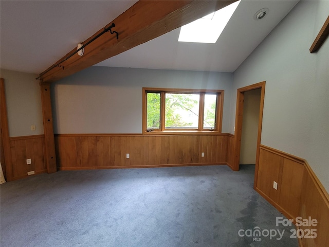 429 Biodome Dr, Waynesville, NC 28785 - empty room with wainscoting, wooden walls, a skylight, carpet, and vaulted ceiling