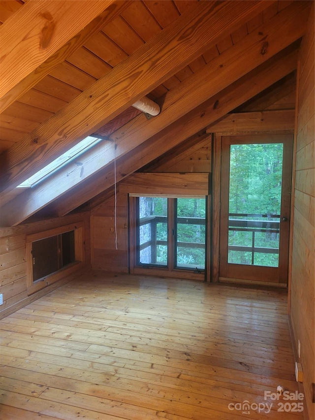 429 Biodome Dr, Waynesville, NC 28785 - bonus room featuring lofted ceiling, a skylight, wooden walls, and hardwood / wood-style flooring