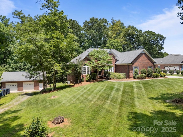10501 Mount Olive Estates Dr Unit 7, Mount Pleasant, NC 28124 - view of front of house featuring brick siding, a front yard, and a garage