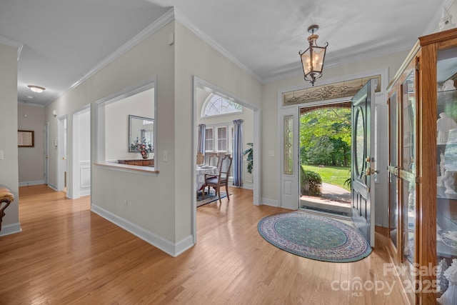 10501 Mount Olive Estates Dr Unit 7, Mount Pleasant, NC 28124 - entrance foyer with light wood finished floors, crown molding, baseboards, and a chandelier