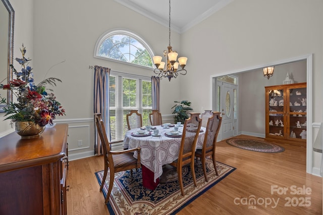 10501 Mount Olive Estates Dr Unit 7, Mount Pleasant, NC 28124 - dining space with a chandelier, crown molding, light wood-type flooring, and high vaulted ceiling