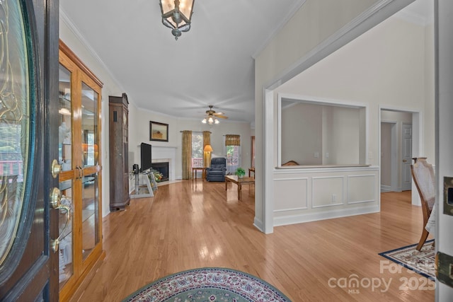 10501 Mount Olive Estates Dr Unit 7, Mount Pleasant, NC 28124 - entryway featuring french doors, crown molding, light wood-style floors, ceiling fan, and a fireplace