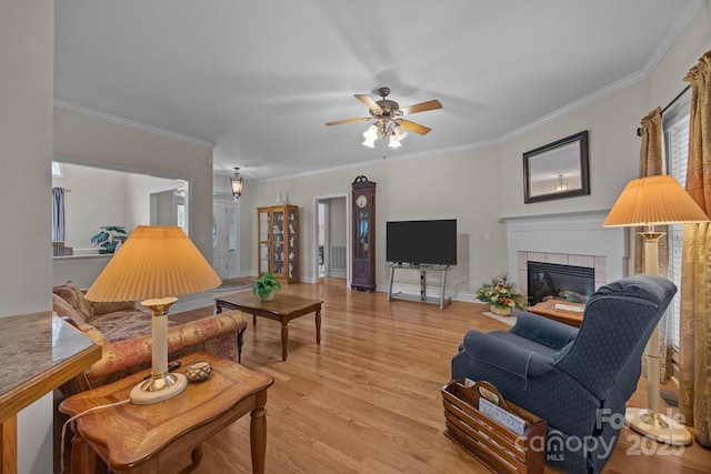 10501 Mount Olive Estates Dr Unit 7, Mount Pleasant, NC 28124 - living area with a tile fireplace, light wood-style floors, ceiling fan, ornamental molding, and baseboards