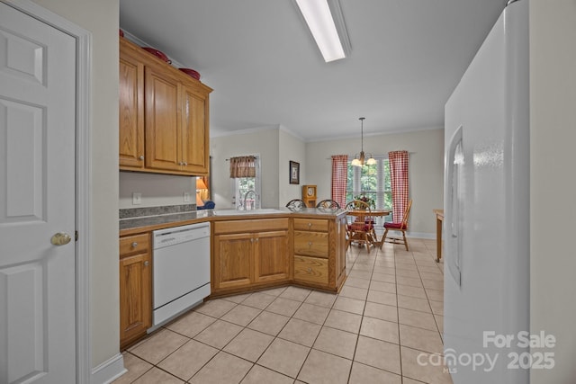 10501 Mount Olive Estates Dr Unit 7, Mount Pleasant, NC 28124 - kitchen featuring white appliances, a peninsula, light tile patterned flooring, a sink, and ornamental molding