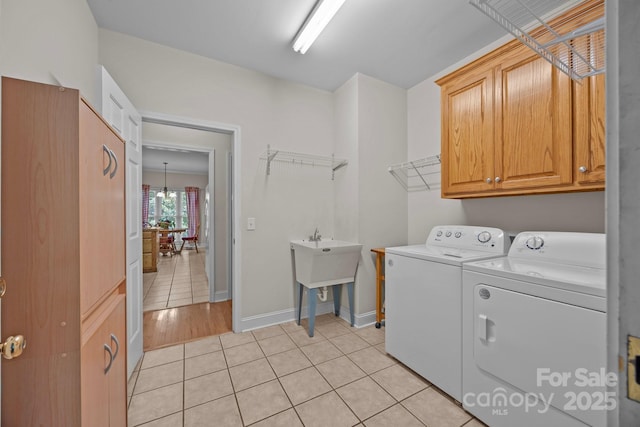 10501 Mount Olive Estates Dr Unit 7, Mount Pleasant, NC 28124 - laundry area featuring cabinet space, separate washer and dryer, light tile patterned flooring, and baseboards