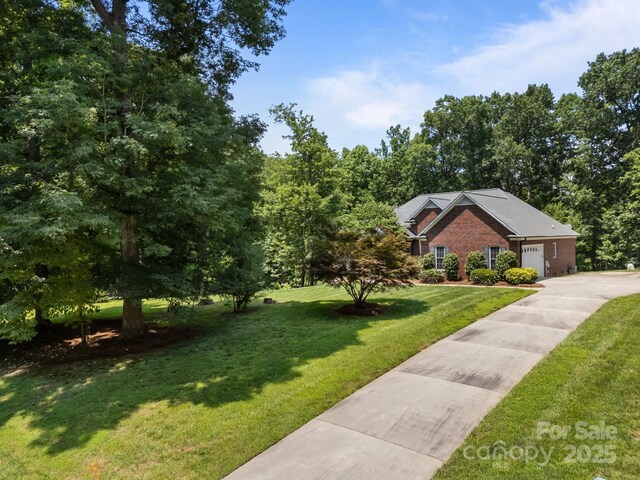 10501 Mount Olive Estates Dr Unit 7, Mount Pleasant, NC 28124 - view of front of property featuring a front yard, brick siding, and concrete driveway