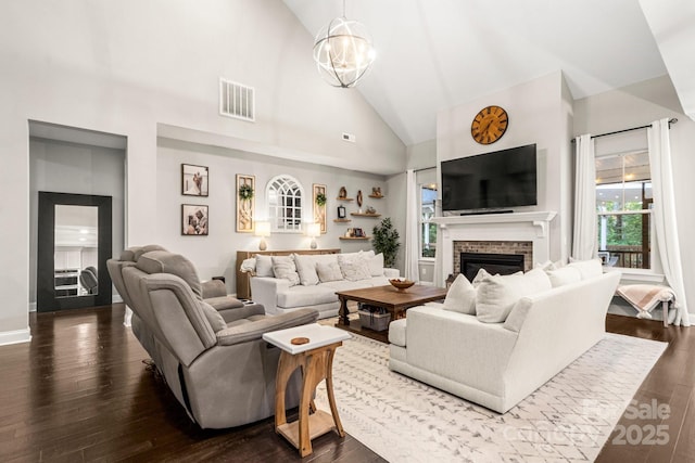 4189 Island Fox Ln, Denver, NC 28037 - living room with high vaulted ceiling, a brick fireplace, dark wood-style floors, and a chandelier