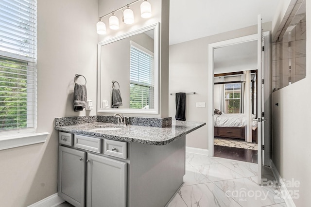 4189 Island Fox Ln, Denver, NC 28037 - full bath with marble look tile flooring, vanity, baseboards, and ensuite bath
