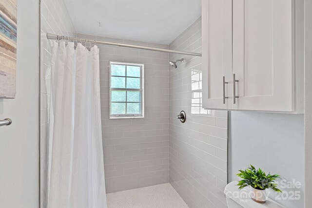 3308 Selwyn Farms Ln Unit 5, Charlotte, NC 28209 - full bathroom with healthy amount of natural light and a tile shower