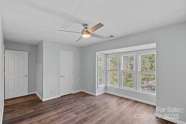 3308 Selwyn Farms Ln Unit 5, Charlotte, NC 28209 - unfurnished bedroom with dark wood-style floors and a ceiling fan